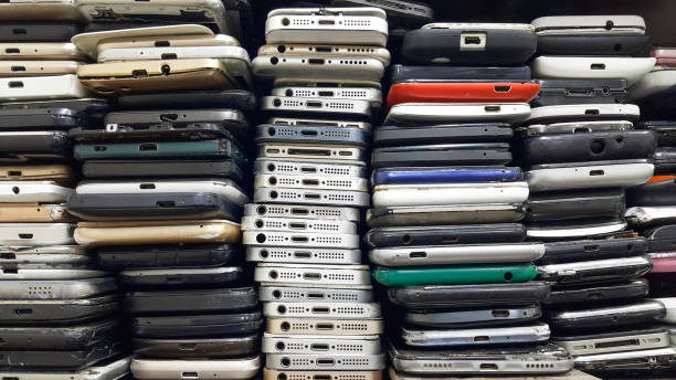 Background of damaged mobile phones. A bunch of broken smartphones. Used phones stacked on top of each other. Repair services and maintenance of equipment. Background of damaged mobile phones. A bunch of broken smartphones. Used phones stacked on top of each other. Repair services and maintenance of equipment. heap stock pictures, royalty-free photos & images