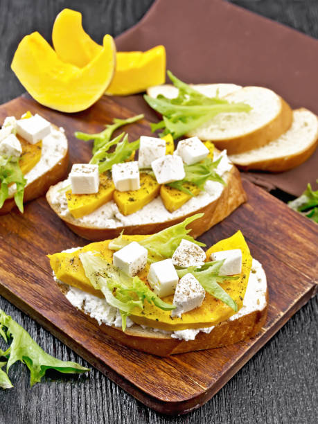 istock Bruschetta with pumpkin and arugula on wooden board 1328099782