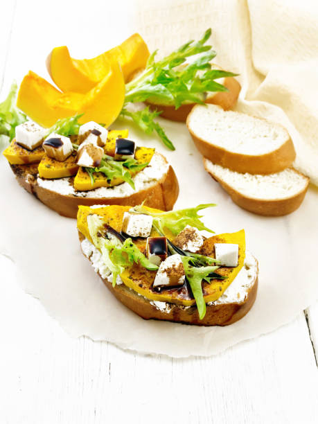 istock Bruschetta with pumpkin and sauce on light board 1328099789