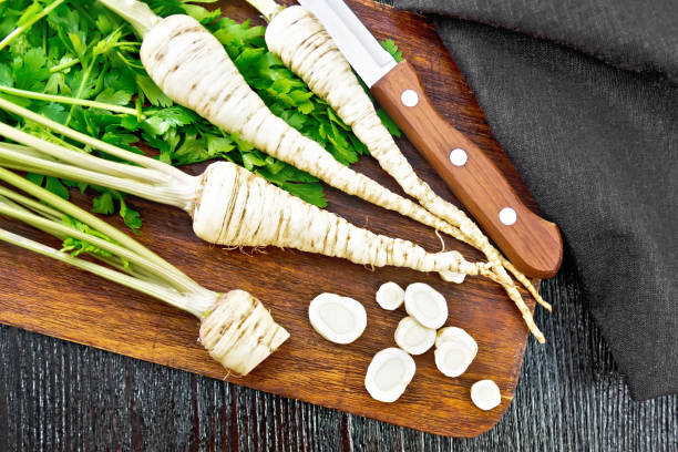 istock Parsley root chopped with knife on dark board top 1328099927