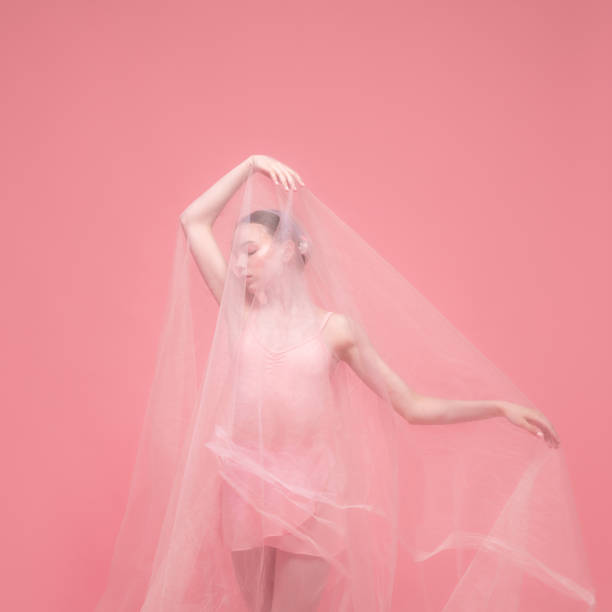 istock One young beautiful graceful ballet dancer dancing with white veiling posing isolated on pink studio background. Art, motion, action, flexibility, inspiration concept. 1328100068