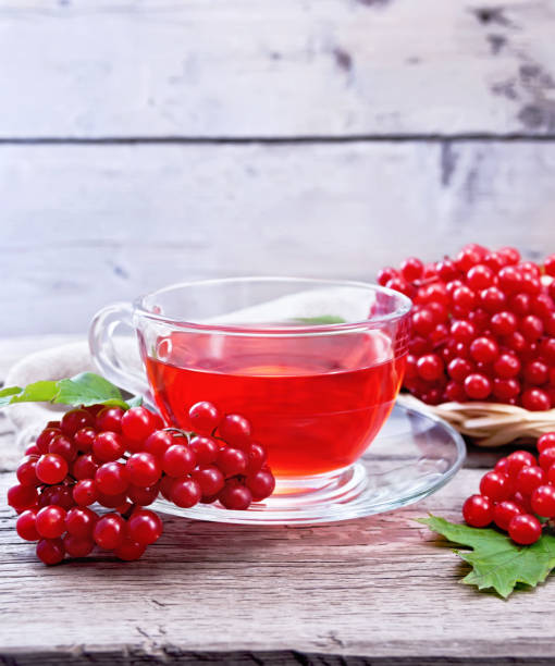 istock Tea from viburnum in cup on old board 1328100171