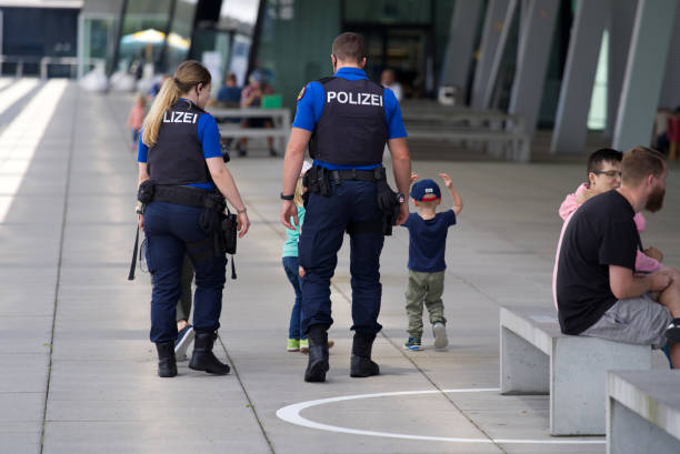 Policemen with children at observation deck of Zurich Airport on summer day. Photo taken July 9th, 2021, Zurich, Switzerland.