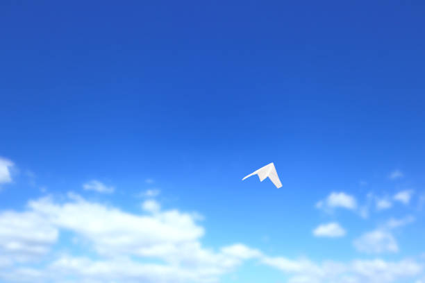 istock Paper airplane flying in the sky. 1328101201