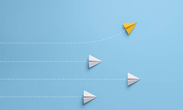 istock Individual and unique leader yellow paper airplane changing direction. 1328104679