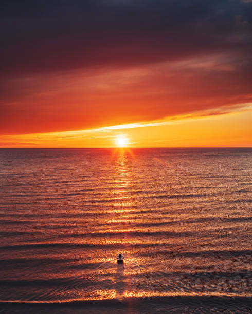 Scenic View Of Boat In The Baltic Sea Against Sky During Sunset stock photo