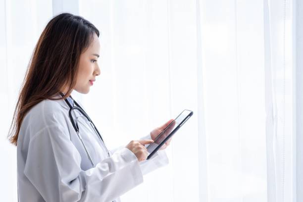 istock The female doctor was browsing the patient's information and taking notes on her tablet 1328109167