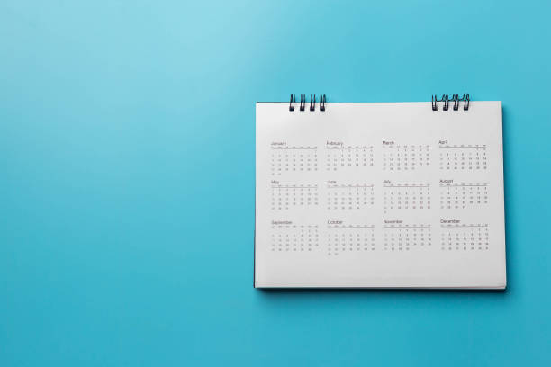 istock Calendar on solid blue background with copy space, business meeting schedule, travel planning or project milestone and reminder concept. 1328110127