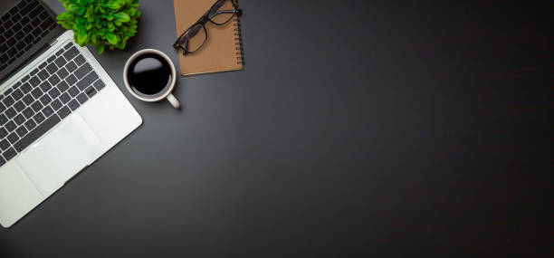 istock Workspace - Flat top view illustration of a workspace with a coffee cup and notebook on the black desk surface,Office desk concept. 1328110133