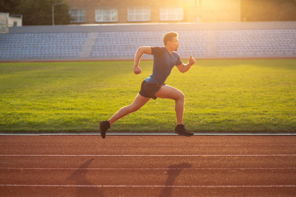 istock Athlete guy wears sport apparel running at the stadium 1328112395