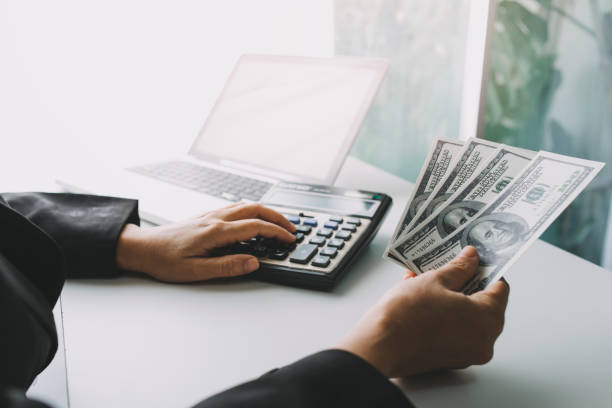 istock Male hand putting coins with money stack step growing growth and dollar bag. saving money, Concept finance business investment. 1328112646