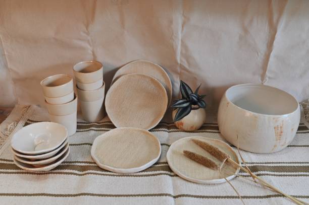 istock Ceramic bowls, glasses, plates, vase, candle holder arranged on a table 1328114301