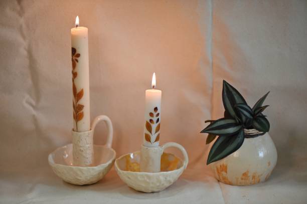 istock Ceramic candleholders with candles and a beautiful ceramic planters arranged on a table 1328114327