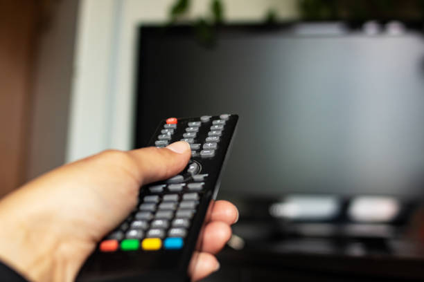 istock TV remote in hand in the room 1328116884