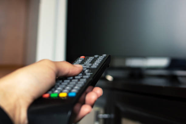 istock TV remote in hand in the room 1328116974