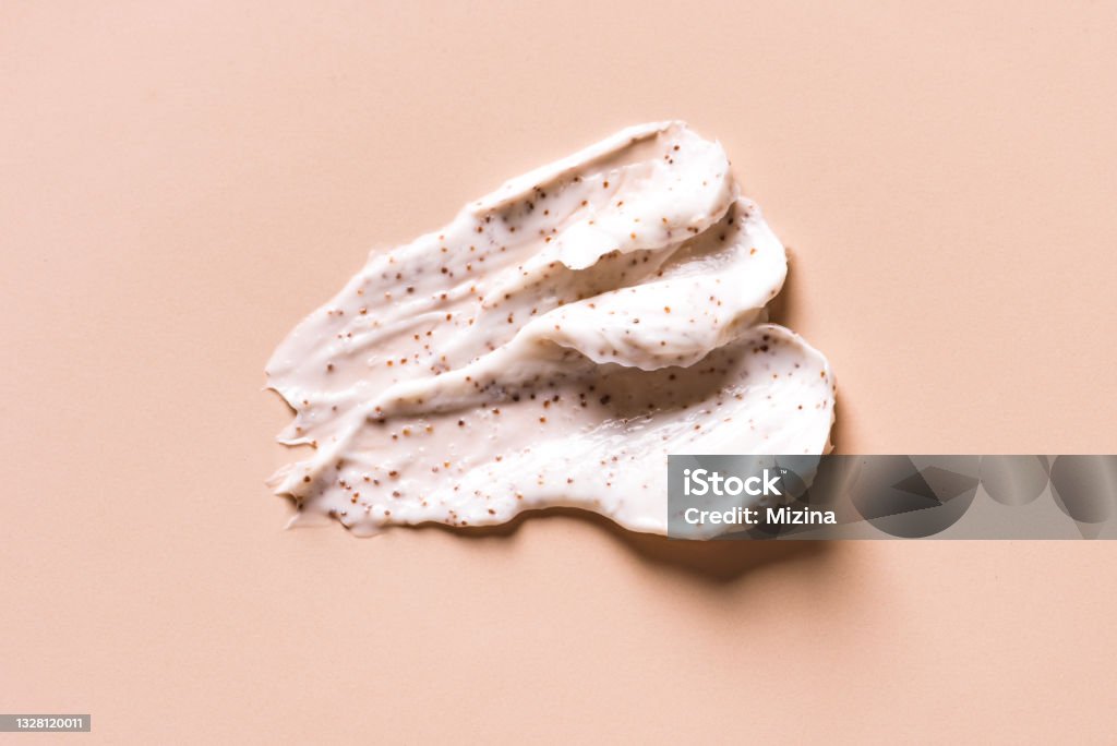 Sample of natural scrub Sample of natural scrub on nude pink background. Peeling cream with microcapsules. Peach or coffee scrub smear. Exfoliation Stock Photo