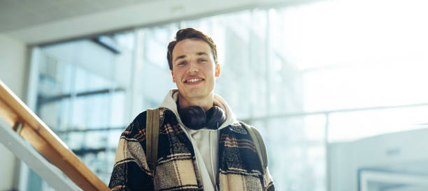 istock Confident male student in college campus 1328120033