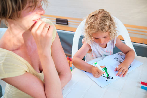 istock young mother teaches her daughter to draw while on vacations in summer 1328121747