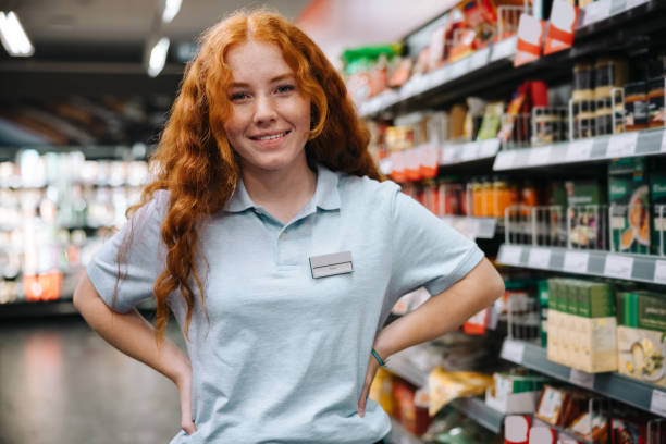 istock Student on holiday job at supermarket 1328122911