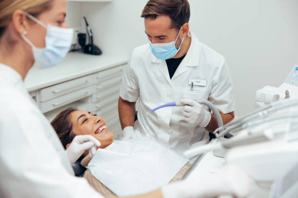 istock Woman smiling during her dental treatment 1328123356