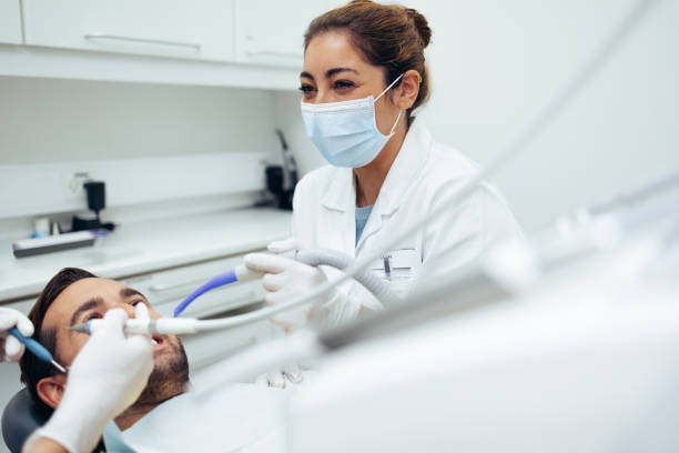 istock Dentist treating a patient in dental clinic 1328124090