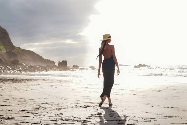 istock Romantic woman relaxing on the empty beautiful island beach. Summer vibes. 1328124646