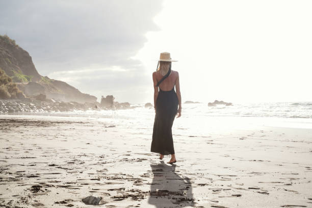 istock Romantic woman relaxing on the empty beautiful island beach. Summer vibes. 1328124685