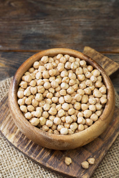 istock Chickpeas in a wooden bowl on a wooden table. Rustic style 1328126216
