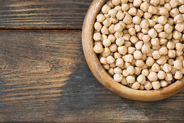 istock Chickpeas in a wooden bowl on a wooden table. Rustic style 1328126221