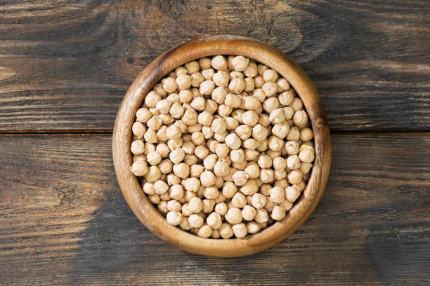istock Chickpeas in a wooden bowl on a wooden table. Rustic style 1328126223