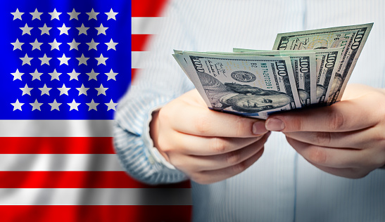 American dollars in hands. Coronavirus economic impact stimulus payments or IRS tax refund