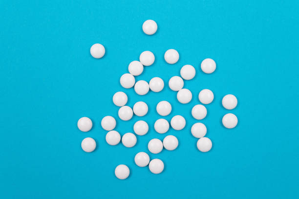 istock Pharmaceutical Industry and Medicinal Products - White Pills on Blue Background 1328129533