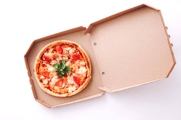 istock Tasty pizza in delivery box on white background 1328130092