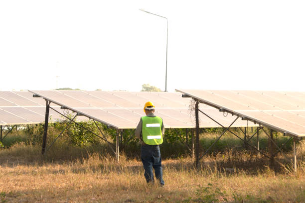 istock Male engineer holding notebook and work record to inspect solar system. Outdoor. Concept of electric power technology industry. 1328131061