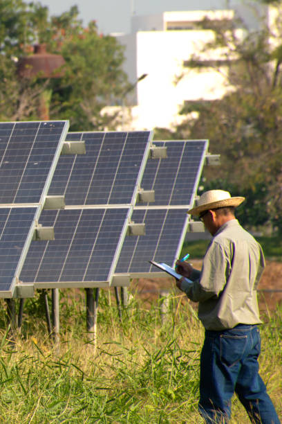 istock Male engineer holding notebook and work record to inspect solar system. Outdoor. Concept of electric power technology industry. 1328131075