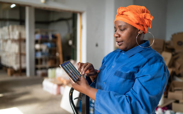istock Afro female warehouse worker checking the shipment delivery on a digital tablet in distribution warehouse 1328131495