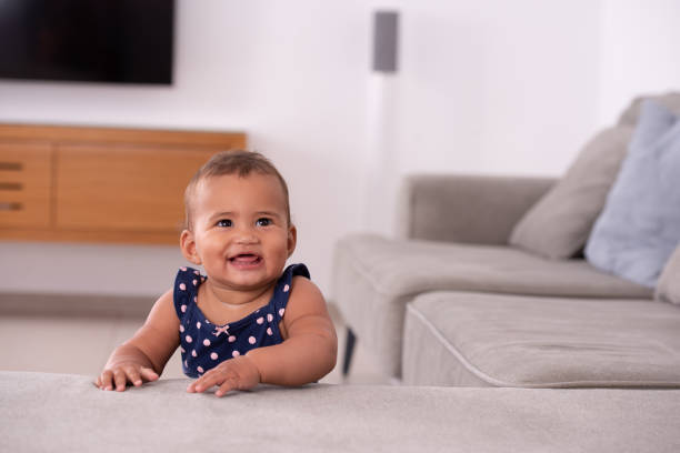 istock Adorable baby leaning on the sofa. 1328135653