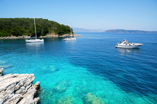 Sailing boats and yacht in a sea, yachting, sailing, travel and active lifestyle concept. Corfu island, Greece