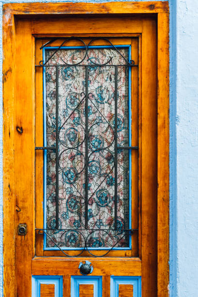 istock Orange wooden door with bars inside 1328141251