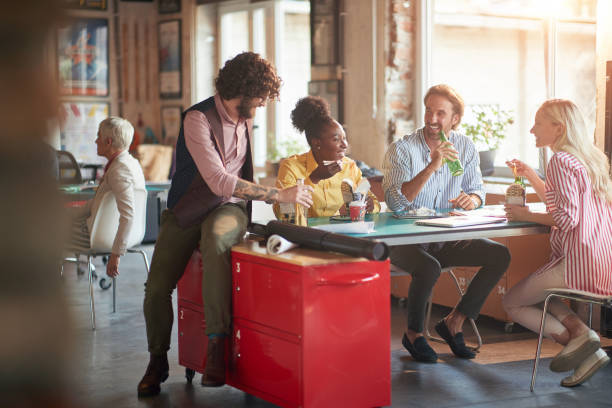 istock Group of young creative people at work is enjoying a time together during a lunch break in the office 1328141767