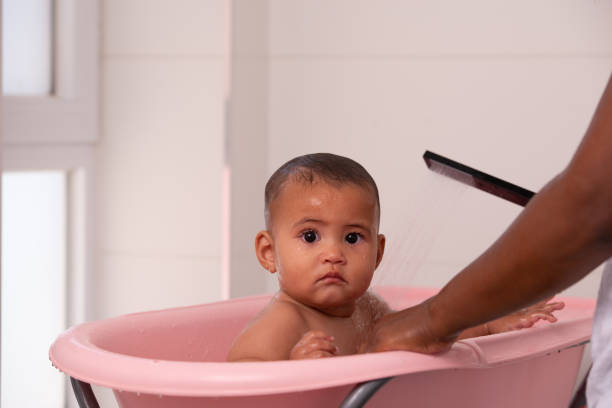 istock Little baby girl bathing. 1328141785