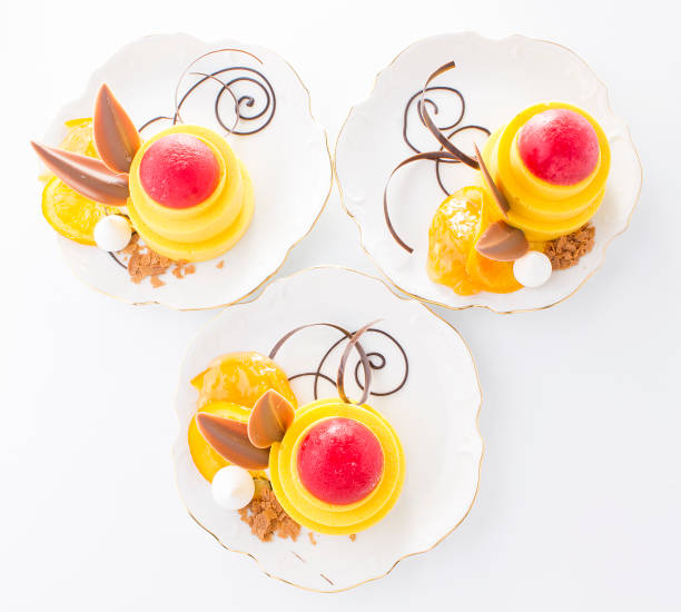 istock Yellow and red cakes with chocolate on white background. 1328145719