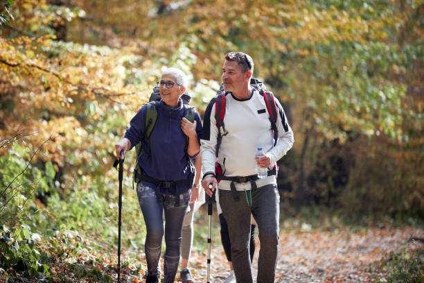 istock An elderly couple on a trail through the woods 1328147263