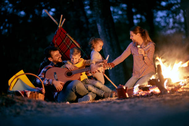 istock A young happy family having playing around a campfire in the forest 1328149447