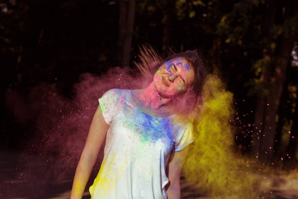 istock Attractive brunette model playing with dry powder Holi 1328149692