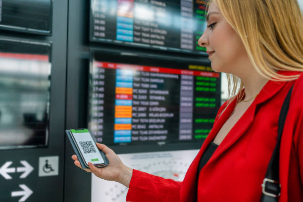 istock Female tourist  checking for her flight in airport 1328149875