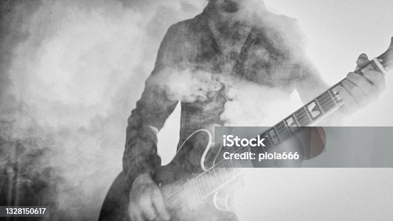 istock Rock guitarist playing guitar in a live show with stage lights 1328150617