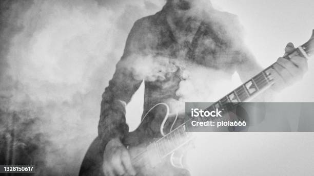 Rock Guitarist Playing Guitar In A Live Show With Stage Lights Stock Photo - Download Image Now