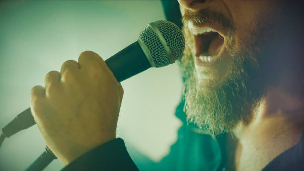 istock Rock singer screaming in a live show with stage lights 1328150695