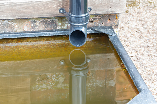 Drain pipe from roof collecting rain water into a water butt conserving precious water for use in the garden.